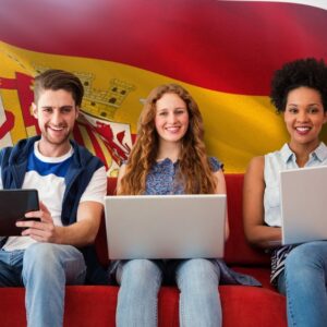 Young adults using electronic devices on couch  against digitally generated spanish national flag